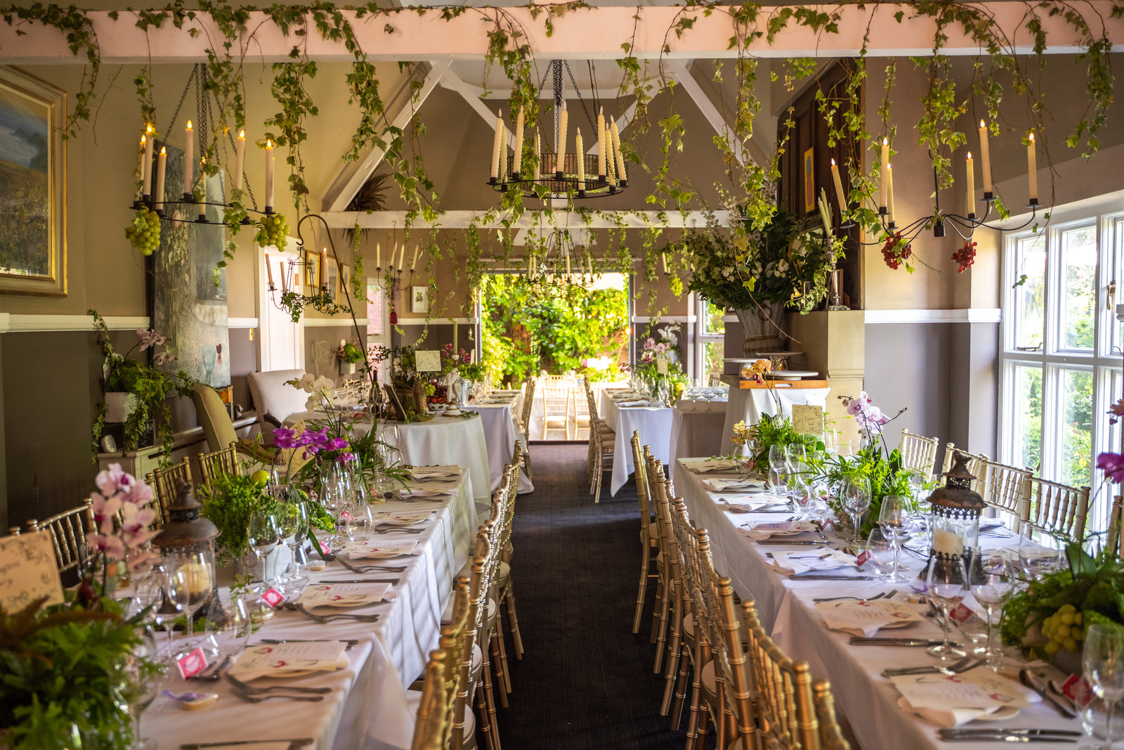 Wedding reception tables dressed with flowers by Flowered Up