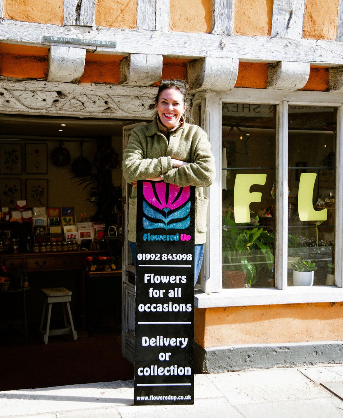 Wendy Shipton at the window of Flowered Up, her florist shop in Hertford