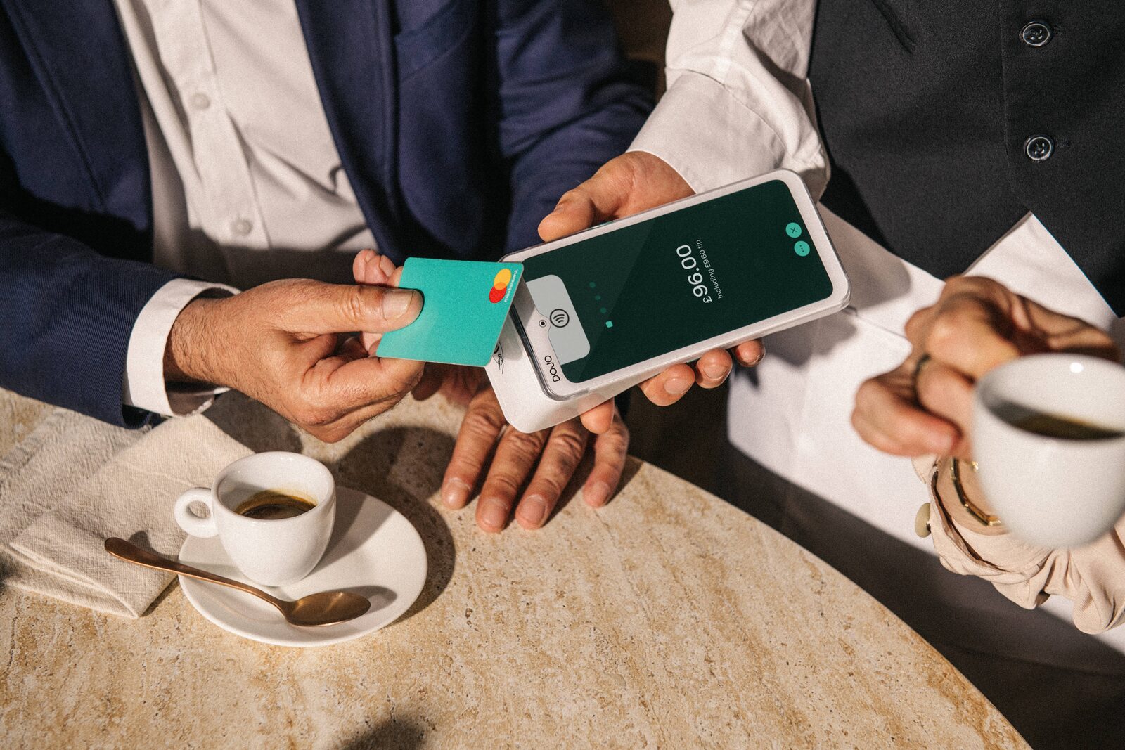 A customer tapping a card on a Dojo Go Max card machine