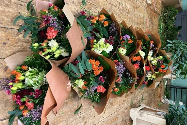 Rows of wrapped bouquets ready for a florist peak day