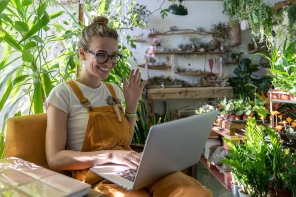 Florist reviewing software on a laptop in a flower shop